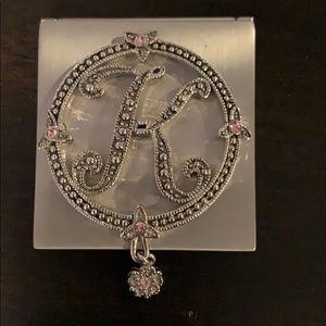 Hand mirror with a K on top